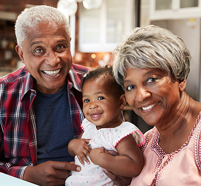 Grandparents holding their grand daughter.